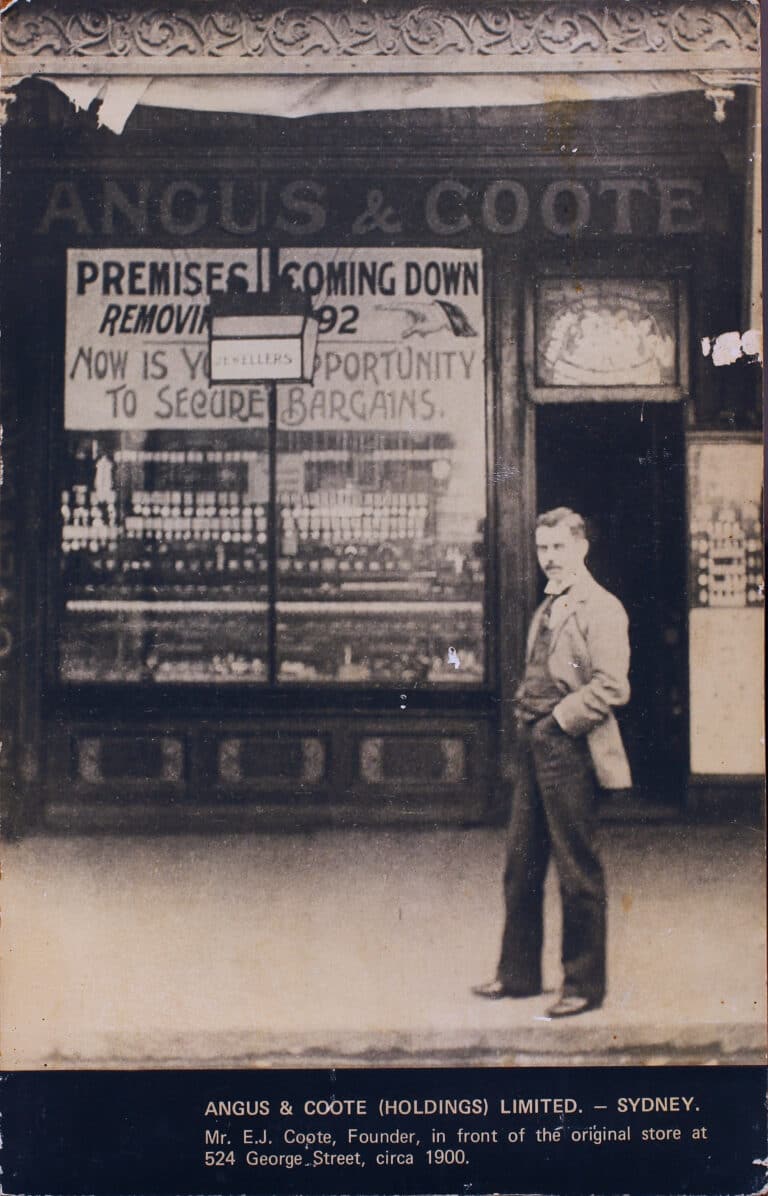 ANGUS & COOTE (HOLDINGS) LIMITED. — SYDNEY.

Mr. E.J. Coote, Founder, in front of the original store at
524 George Street, circa 1900.